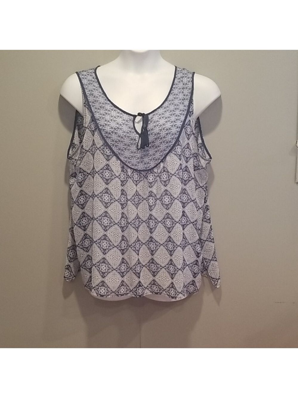 Rose & Olivia blue design sheer sleeveless blouse.